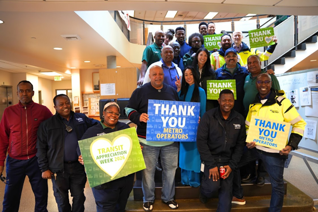 CM. Fain with a group of transit operators on a staircase holding signs saying Thank You Metro Operators