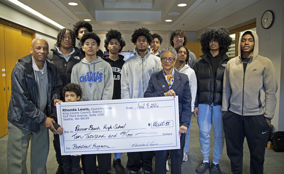 Rhonda Lewis presents a check for $10,000 