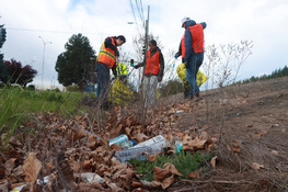 Close up view of trash and employees working along Airport Way South April 2026