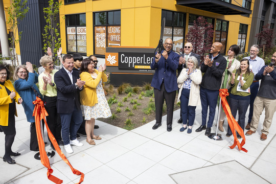 Executive and partners celebrate ribbon cutting 