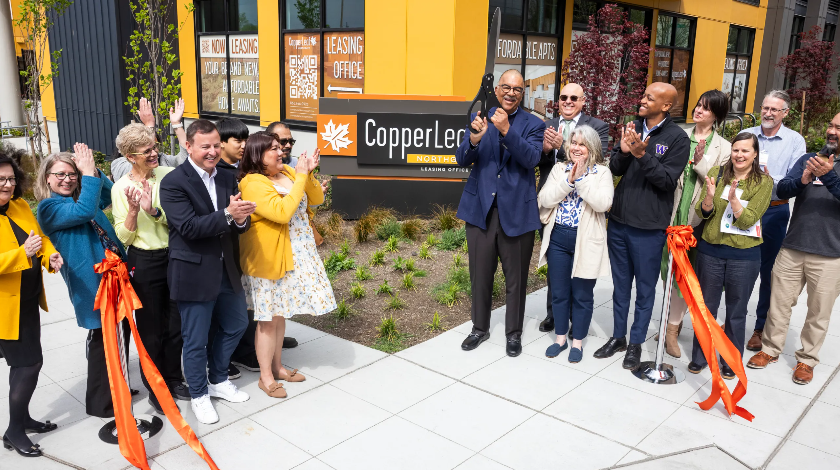 image of 15+ people standing in front of Copperleaf after just butting the ribbon to open it