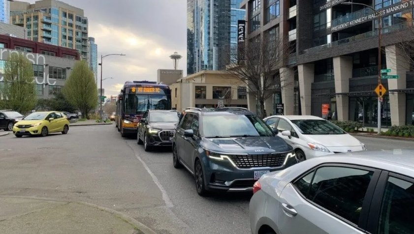 Image of a route 8 stuck on Denny behind multiple sov cars