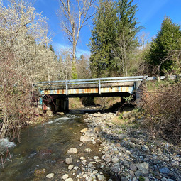 Rusty bridge across a stream