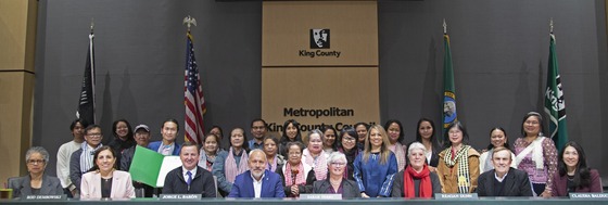 An image captured in the King County Council chambers, featuring community members alongside Councilmembers.