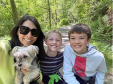 Steffanie with her two boys and dog on a trail