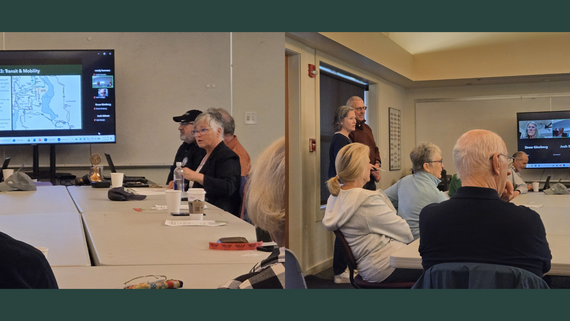 Left: A seated woman speaks with a presentation on a screen next to her. Right: Two people stand, speaking to people sitting around a table.