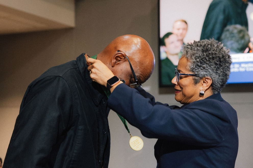 photo of CM Rhonda Lewis putting the MLK award on Gregory Davis