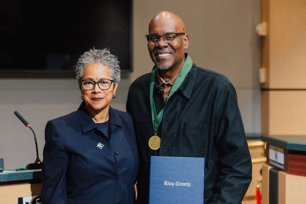 cm Rhonda Lewis standing with Gregory Davis in council chambers