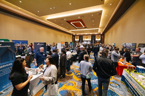 ballroom filled with people mingling at an outreach event