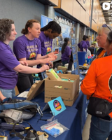 group of people talking to attendees at Women in Trades fair