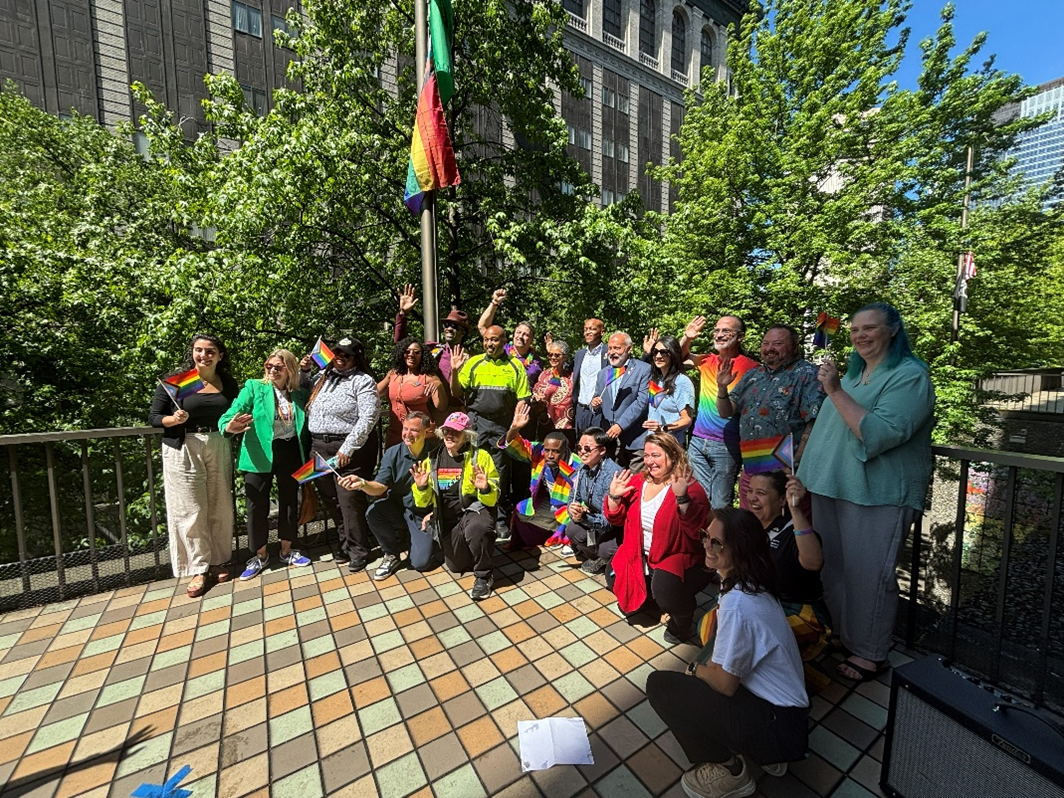 Councilmembers join the flag raising for Pride at the King County Administration building.