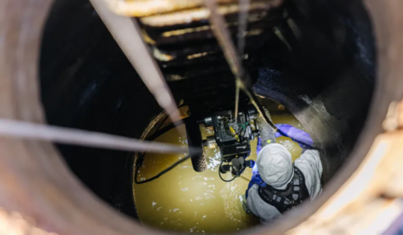 Conveyance inspector inspecting a sewer line.