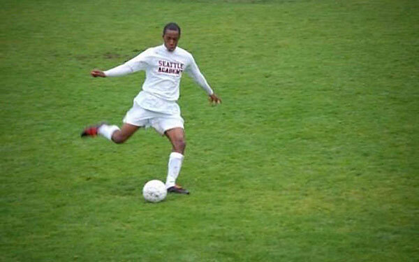 photo of a person kicking a soccer ball