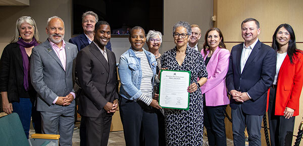 Photo of councilmembers standing with members of the NAAM board
