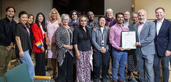 Photo of a group of people standing in council chambers
