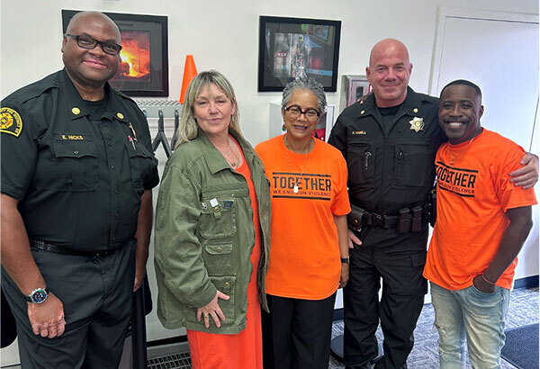 Councilmember Lewis standing with four other people.