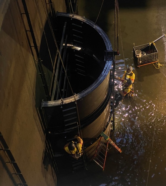 Contractor crews build a cofferdam to move equipment