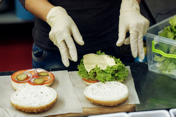 A person preparing hamburgers