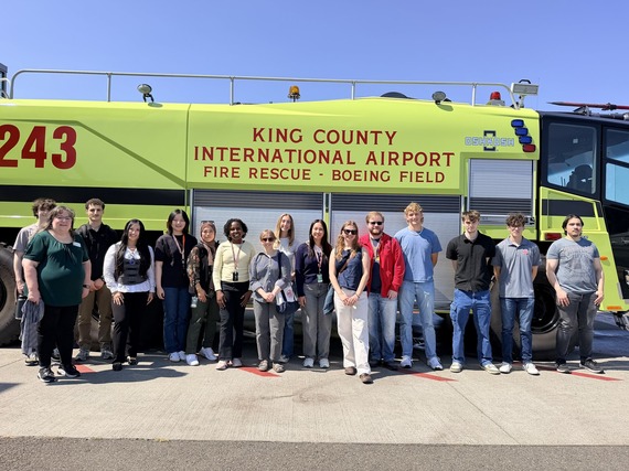 group of interns in front of fire engine