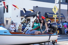Photo of CM. Fain and Highline College President on a boat in a parade waving