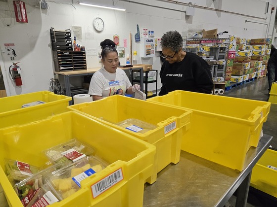 Councilmember Lewis packing and organizing produce at Food Lifeline