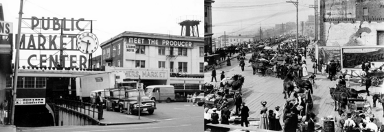 Black-and-white collage showing a building labeled PUBLIC MARKET CENTER with people and cars & crowded Pike Place Market.