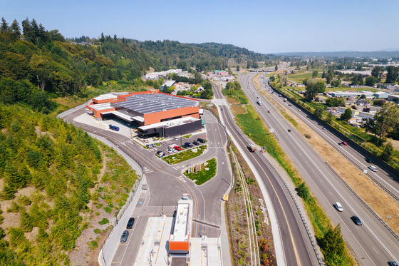 Aerial view of South County Recycling & Transfer Station, a large modern building complex with parking, along W Valley Hwy & SR 167.