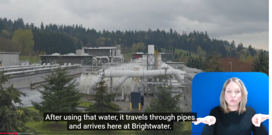 Screenshot of Brightwater video on YouTube showing aerial view of treatment plant with caption and ASL interpreter.