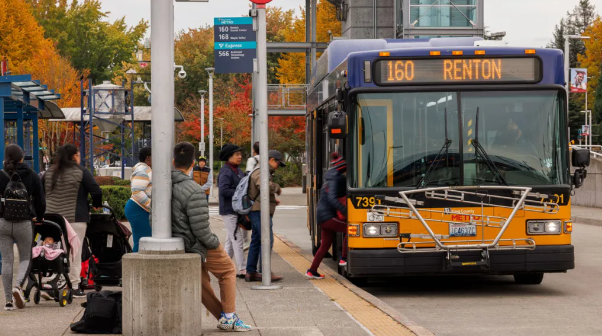 picture of a route 160 to Renton stopping at a Transit Center and riders are boarding 