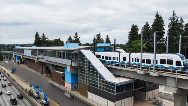 Arial photo of the Pinehurst Station with a Link light rail pulling into the station 
