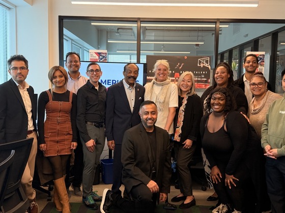 A group of people standing in an office