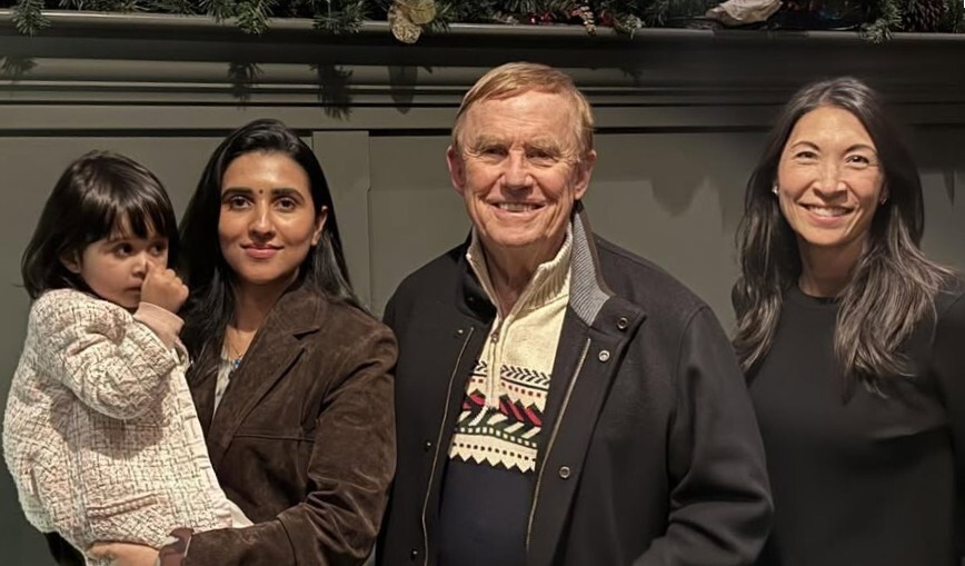 Four people pose for a group photo