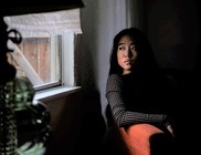 Asian woman in lighter setting