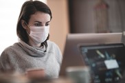 masked woman at computer