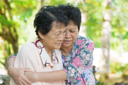 senior asian women embracing