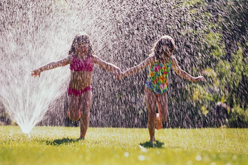 Kids playing in a sprinkler