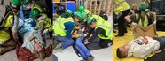 volunteers play injured community members during training drill