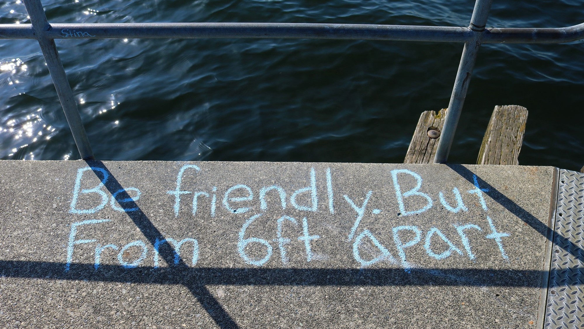 Chalk on a pier that says 