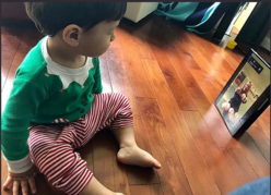 Virtual Move and grow class image - child in front of tablet