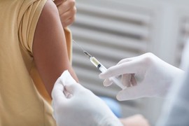 child's arm receiving a vaccine shot