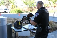 officer inspecting a gun