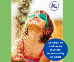 child playing in sprinklers
