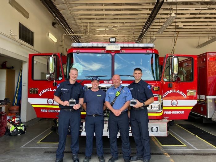 New Firefighters posing for picture in front of an engine truck