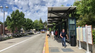 bus station downtown with people on sunny day.jpg