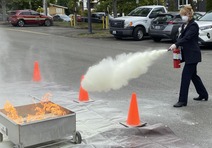 City staff using fire extinguisher