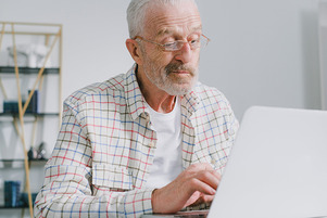 Skeptical Grandpa with Laptop