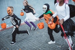 halloween trick or treaters running