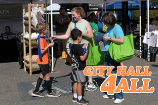 Photo of children and adults at an outdoor fair 