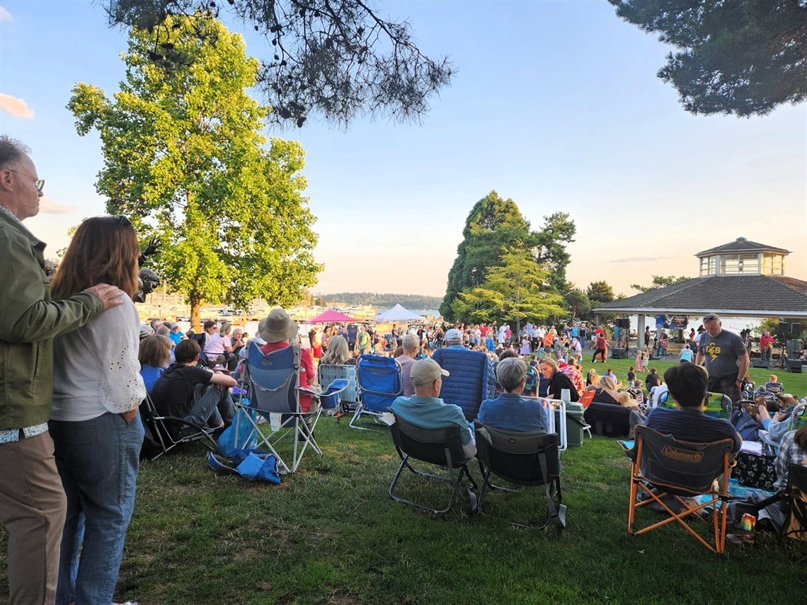 Photo of people gathered outdoor at a marina