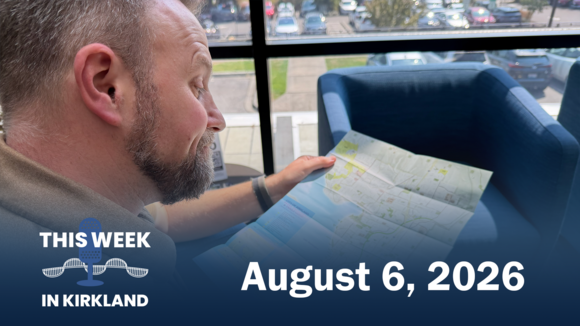 Photo of a man sitting in a chair reading a map